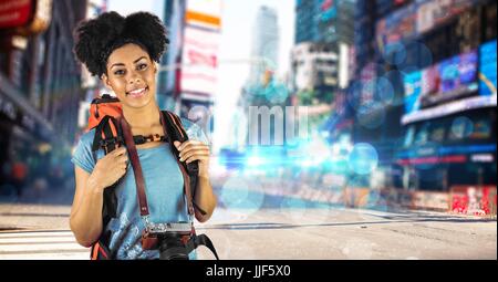 Digital composite of Beautiful woman carrying backpack and camera travelling in city Stock Photo