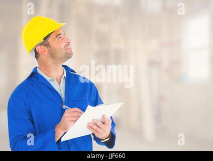Digital composite of Construction Worker with pen chart in front of construction site Stock Photo