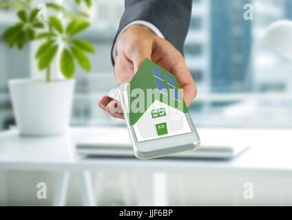 Digital composite of solar panel green house on hand in the office Stock Photo