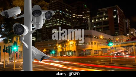 Digital composite of CCTV cameras against light trails in city at night Stock Photo