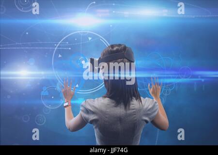 Digital composite of lady with virtual reality headset Stock Photo