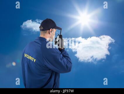 Digital composite of Rear view of security guard talking on walkie talkie against sky Stock Photo