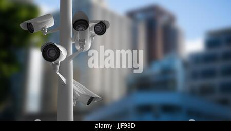 Digital composite of CCTV cameras against defocused buildings Stock Photo