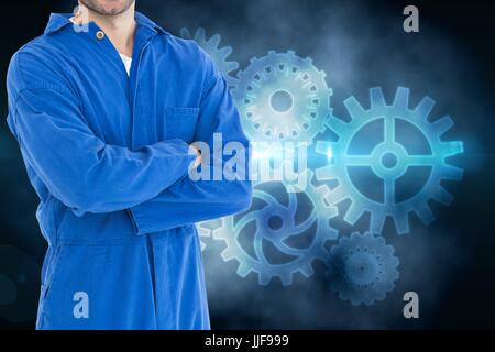 Digital composite of mechanic against background with cogs Stock Photo