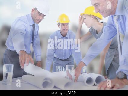 Digital composite of Architect with blueprints on building site Stock Photo