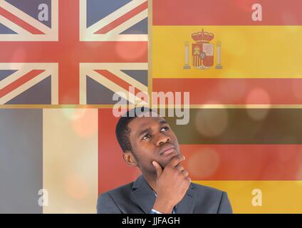 Digital composite of main language flags overlap with gold lights around young man thinking Stock Photo