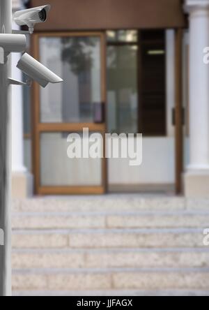 Digital composite of cctv stick in front of a store door Stock Photo