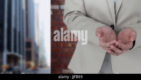 Digital composite of Hands asking for help in city Stock Photo