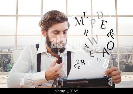 Digital composite of Hipster man with a pipe reflecting on his typewriter in front of sea background Stock Photo