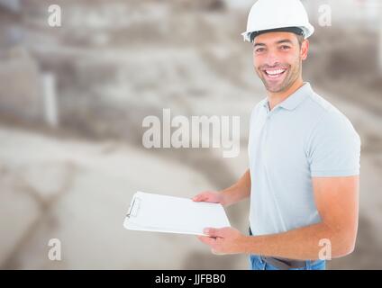 Digital composite of Construction Worker with chart in front of construction site Stock Photo
