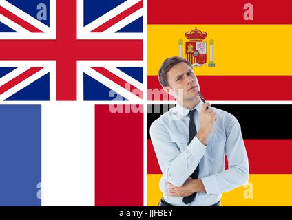 Digital composite of main language flags around thoughtful man Stock Photo