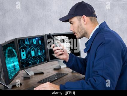 Digital composite of security guard with locks on the screens speaking with the walkie-talkie in his office Stock Photo