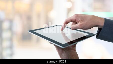 Digital composite of Businessman touching tablet in public Stock Photo