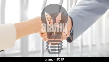 Digital composite of Close up of handshake with grey lightbulb graphic Stock Photo
