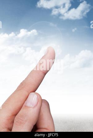 Digital composite of Hand touching air with sky background Stock Photo