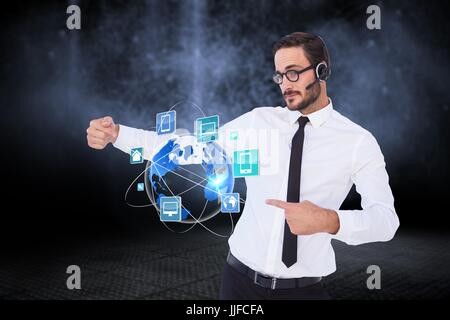 Digital composite of Business man presenting icons and wearing Headset Stock Photo