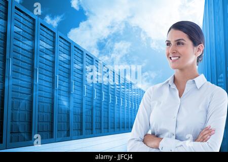 Digital composite of Business woman with arm crossed against the server room Stock Photo