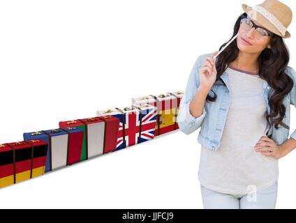 Digital composite of main language flag suitcases behind young woman with hat. Stock Photo