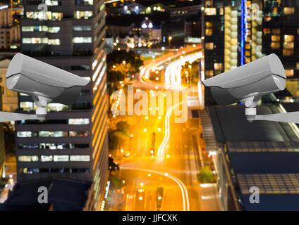 Digital composite of High angle view of CCTV cameras against lights in city Stock Photo