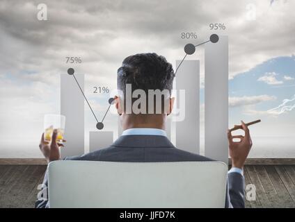 Digital composite of Rear view of businessman sitting on chair with glass of alcohol examining graph while smoking cigar Stock Photo
