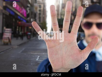 Digital composite of Man with stop hand gesture on street Stock Photo
