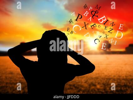 Digital composite of woman silhouette with text coming up from the head and the hands on the head. Field with sunset Stock Photo
