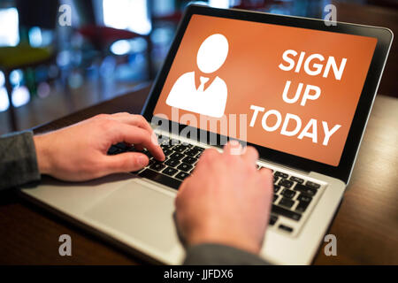 Sign Up Now text with human icon on brown screen against cropped image of businessman Stock Photo