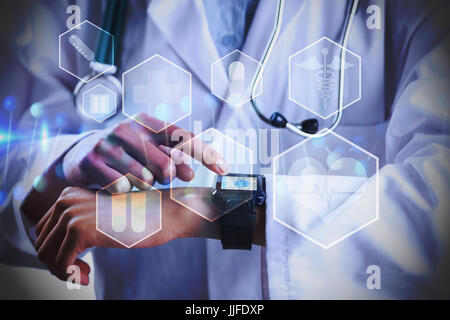 Mid section of female doctor using smart watch against medical icons in hexagons interface menu Stock Photo