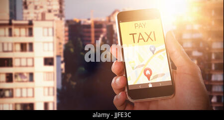 Close-up of hand holding mobile against glowing background Stock Photo