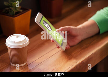Vector image of Sign Up Now text with icons  against woman hand using smart phone at table Stock Photo