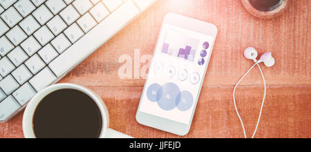 Blue icons on white background against coffee and white smartphone with headphones Stock Photo