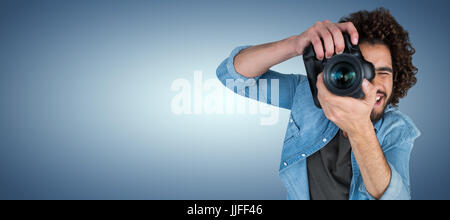 High angle view of male photographer taking picture  against purple vignette Stock Photo