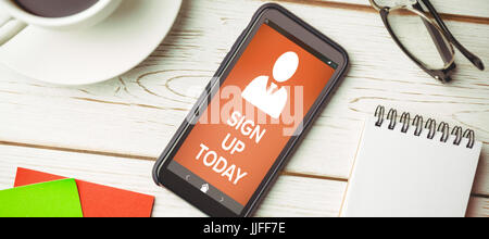 Vector image of Sign Up Now text with human icon  against overhead view of an desk Stock Photo