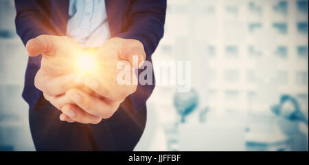 Womans hands cupped  against digital image of laptop on table against adhesive notes Stock Photo