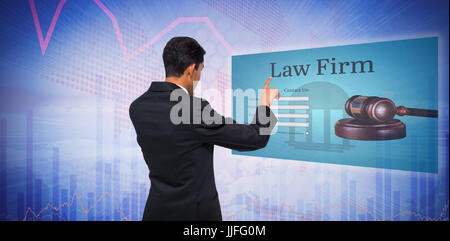 Thoughtful asian businessman pointing against stocks and shares Stock Photo