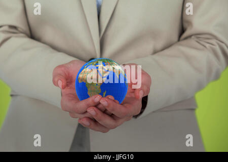 Womans hands cupped  against green background Stock Photo