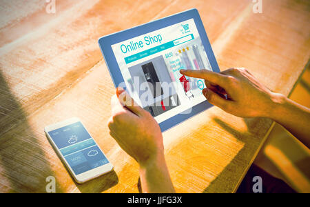 Washing machines for sale displayed on web page against over shoulder view of casual man using tablet Stock Photo