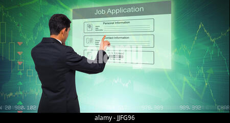 Thoughtful asian businessman pointing against stocks and shares Stock Photo
