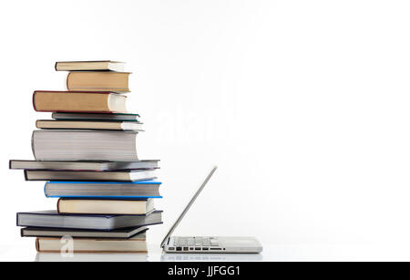 Education concept. Books stack and a laptop isolated on white background - copy space Stock Photo