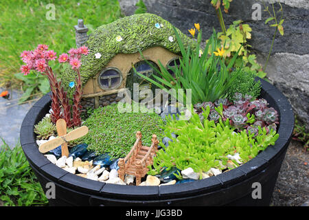 Amusing Fairytale Rockery Garden in Patio Tub Stock Photo