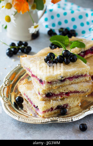 Homemade baking. Cookies with black currant jam on a gray stone or slate background. Stock Photo