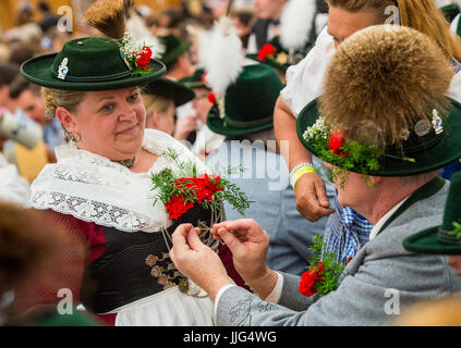 Two persons wearing traditional costumes stand in the 'Oide Wiesn' festival tent after the costume and shooting club parade at the Oktoberfest in Munich (Bavaria), Germany, 21 September 2014. The annual beer festival runs from 20 September to 05 October. Photo: Marc Mueller/dpa | usage worldwide Stock Photo
