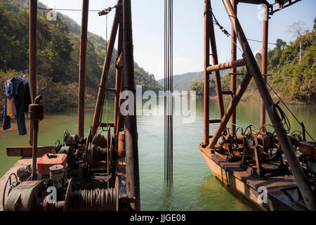 Rear view of a Vietnamese mechanical gold dredge floating on the Nam Ou River, Laos. Stock Photo