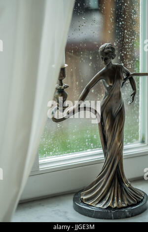 Vintage candlestick with candles on a background of a rainy window. Soft focus, selective focus Stock Photo