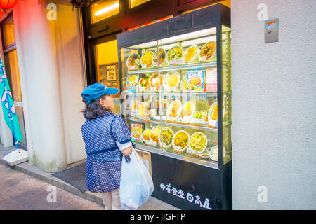 HAKONE, JAPAN - JULY 02, 2017: Unidentified woman looking at food store at street. Stock Photo