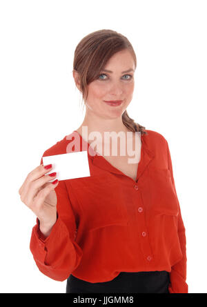 A beautiful woman in a red blouse and brunette hair holding an empty business card up, smiling, isolated for white background. Stock Photo