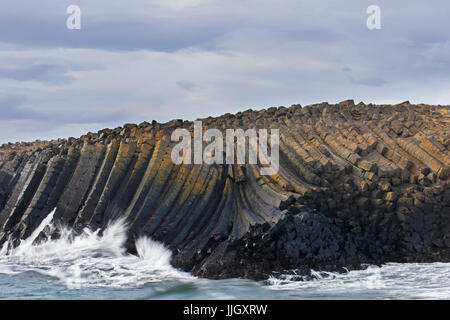 Waves crashing on basalt columns, volcanic lava formations in sea cliff near Kalfshamarsvik cove, Kalfshamar Peninsula, Skagi, Iceland Stock Photo