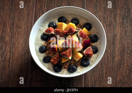 Healthy breakfast soy yogurt with melon figs and blueberries whole foods vegan Stock Photo