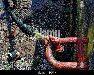 Rusted anchor chain in deep blue ocean connecting surface vessel to ...