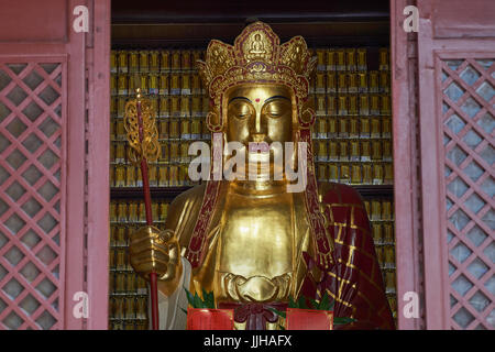 Closeup of Golden Buddha statue in Dafo Temple (also Big Buddha Temple), one of Guangzhou's most popular temples - Guangzhou, China